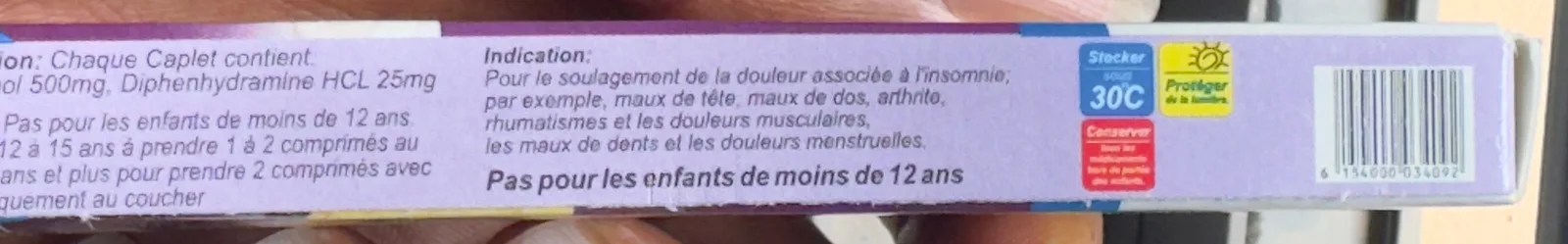The narrow side panel of the Emzor ParaNight carton: composition, directions, indication, storage symbols and a barcode. The left edge of the text is cut off by the photo.