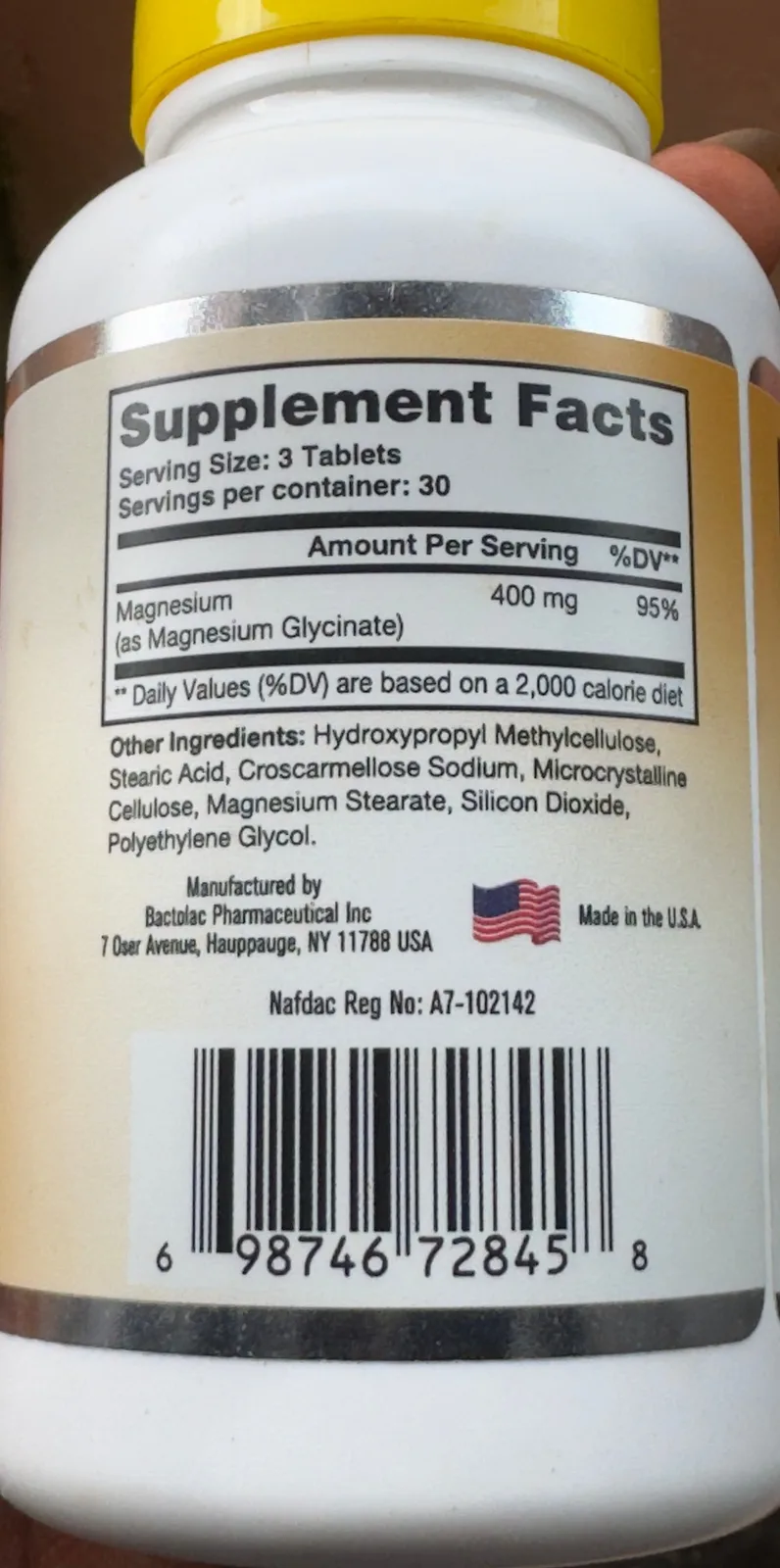 The back of a magnesium glycinate supplement bottle: Supplement Facts, ingredients, a NAFDAC registration number and a barcode.